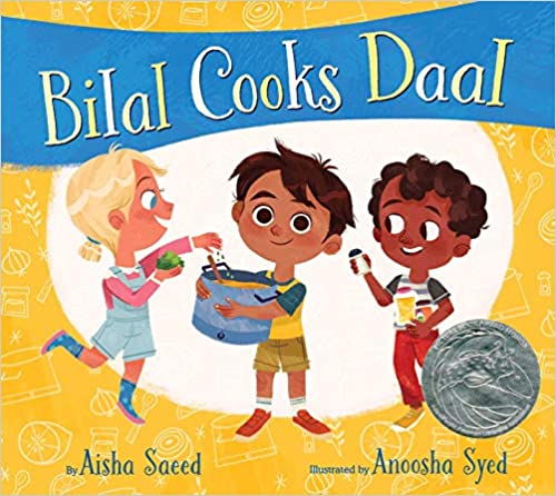 Illustrated book cover for Bilal Cooks Daal shows three children smiling. The boy in the center holds a pot, while the two others offer spices and a cup. The background is yellow with a blue banner and a silver award medal.