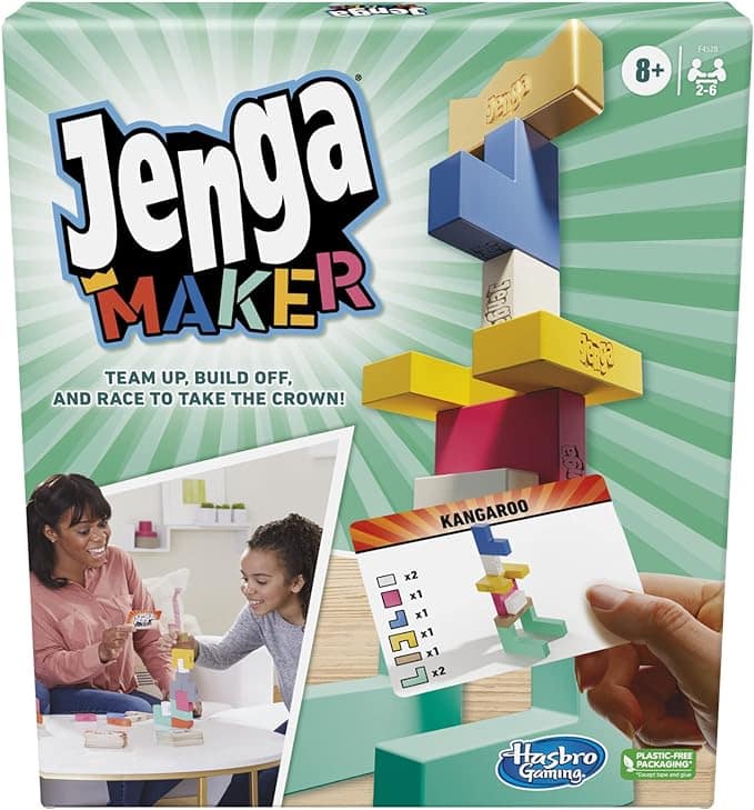 Front of the Jenga Maker game box showing two people playing with colorful Jenga blocks and a hand holding a card labeled Kangaroo. The box features bold text and bright, playful graphics.