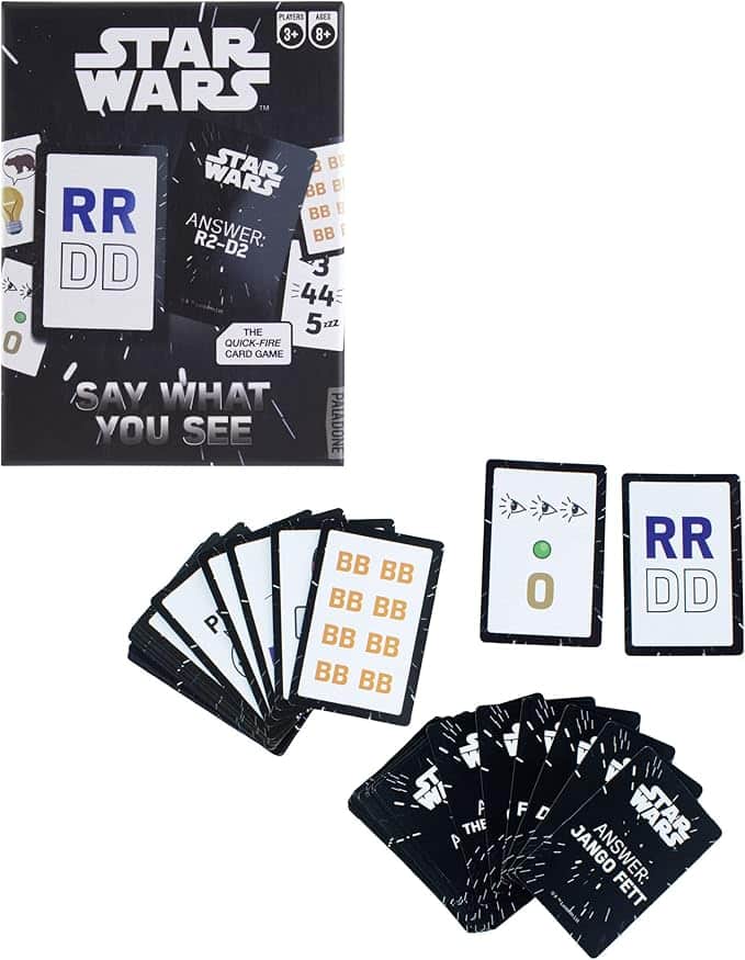 Star Wars-themed card game called Say What You See, showing the box, several black cards with letters like RR, DD, BB, and answer cards with character names and numbers spread out.
