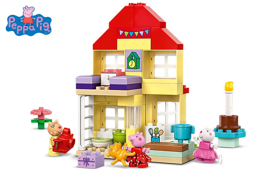A colorful Peppa Pig-themed toy house with Peppa Pig, her family, and friends figurines. The set includes furniture, a cake, presents, and decorations, with the Peppa Pig logo in the top left corner.