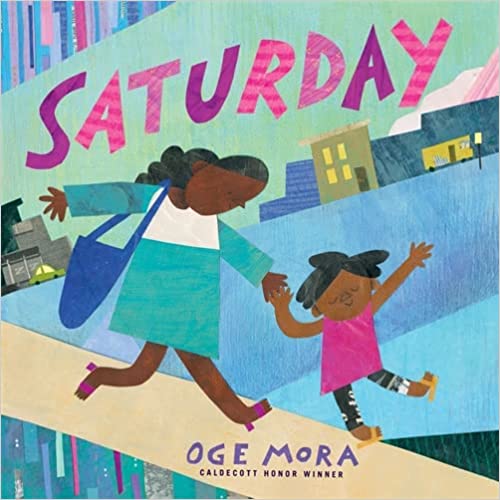 Illustration of a woman and a child holding hands, joyfully walking together on a colorful city street. The word SATURDAY is written in large, colorful letters above them. The artists name, Oge Mora, appears at the bottom.
