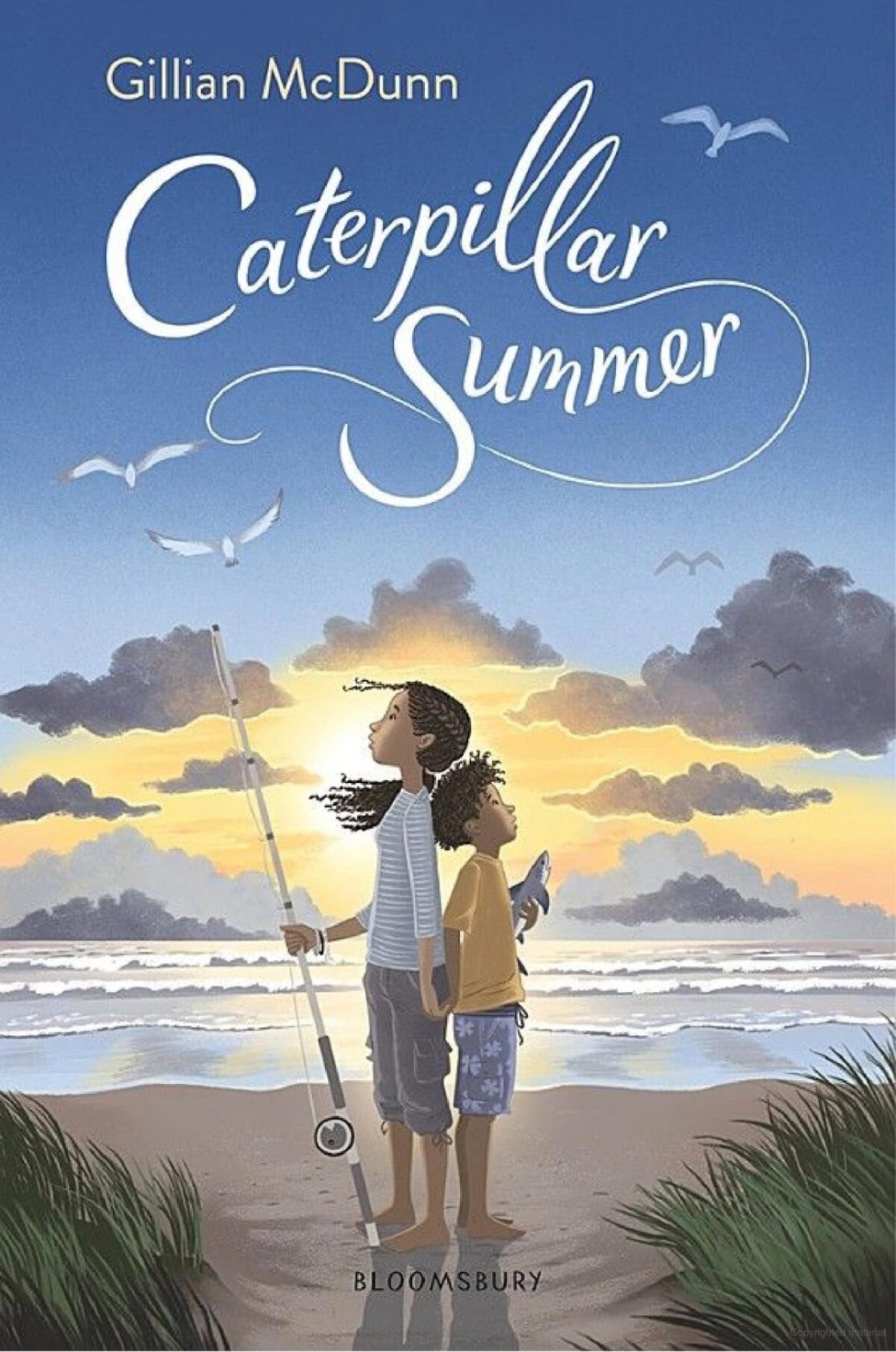 Book cover for Caterpillar Summer by Gillian McDunn shows two children standing on a beach at sunset. One holds a fishing rod, the other looks up at the sky. Seagulls fly overhead and waves roll in behind them.