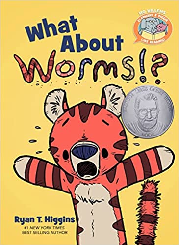 Book cover of What About Worms!? by Ryan T. Higgins. It features an illustrated orange and black tiger with a surprised expression on a yellow background and an award medal on the right side.